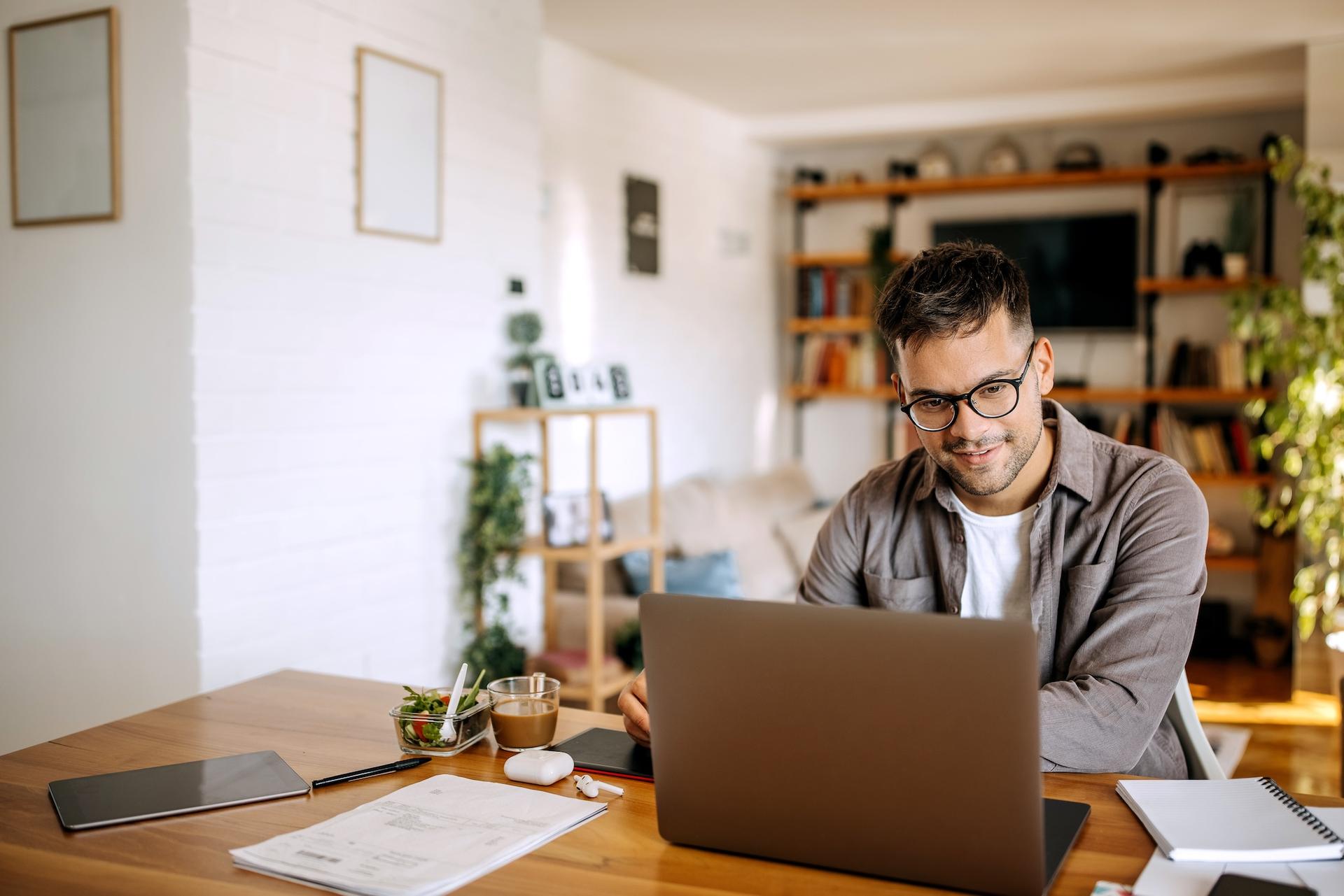 Smiling man working on laptop